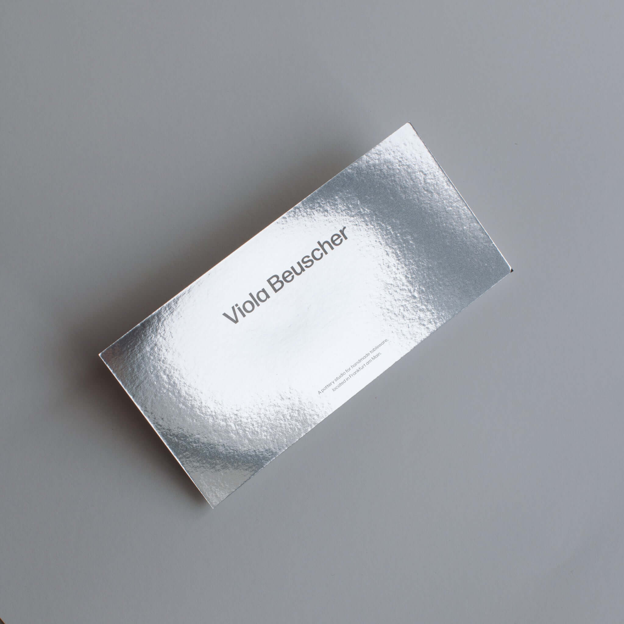 Printed gift card design featuring metallic finish and simple typography.