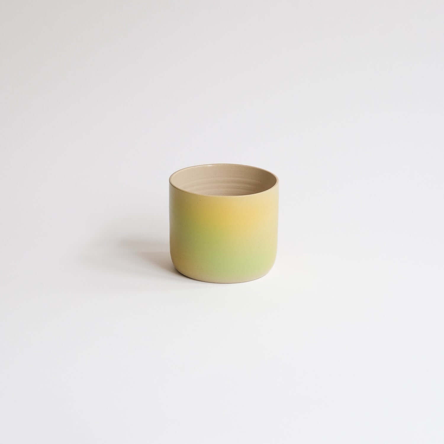 Eye-catching Bloom Cup with vibrant spray-painted design. Perfect size for your coffee delight. Artisanal charm in every sip! from viola beuscher ceramics