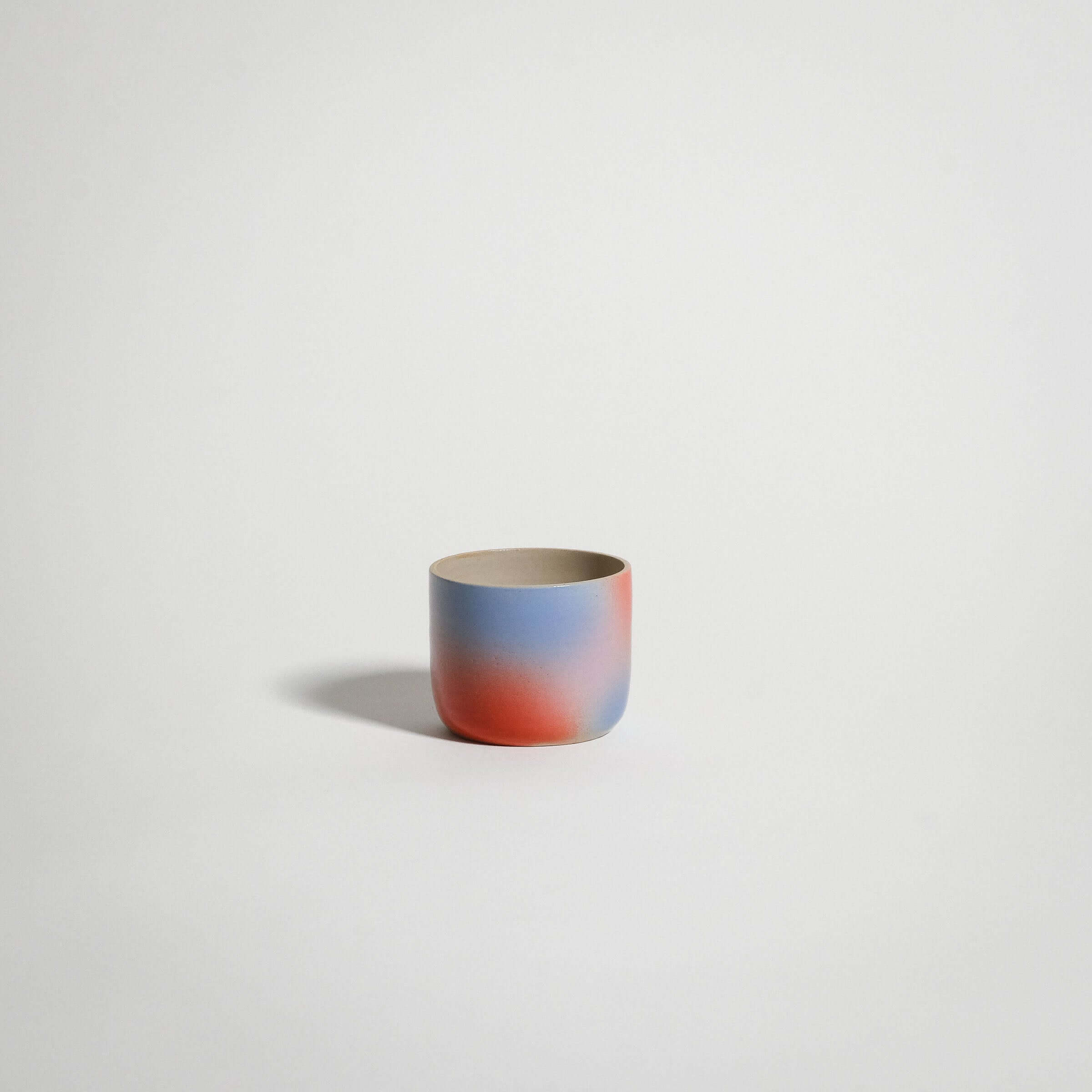 Dawn Espresso Cup handcrafted stoneware in red, blue, and lilac gradient finish.