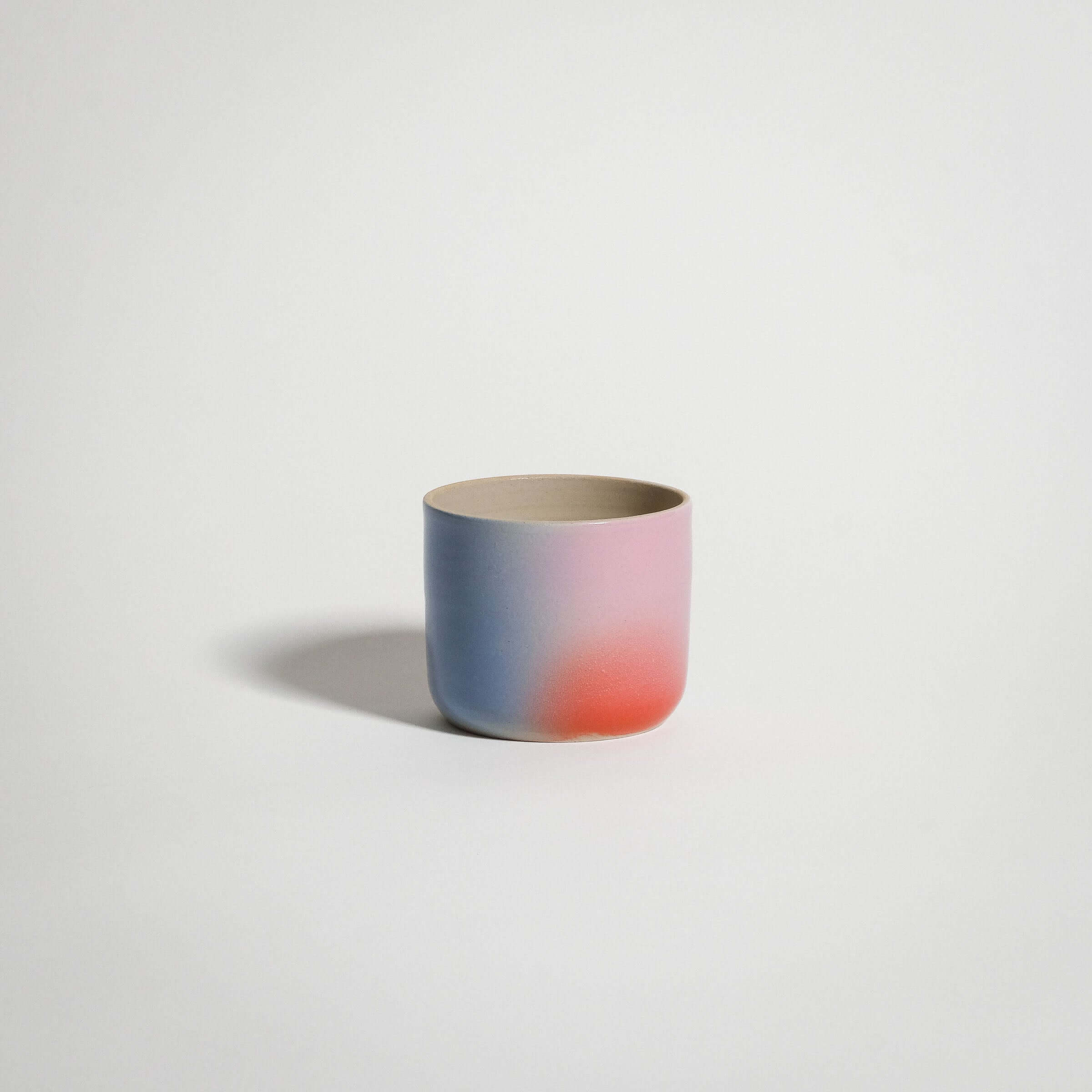 Dawn Coffee Cup handcrafted stoneware in red, blue, and lilac gradient finish.