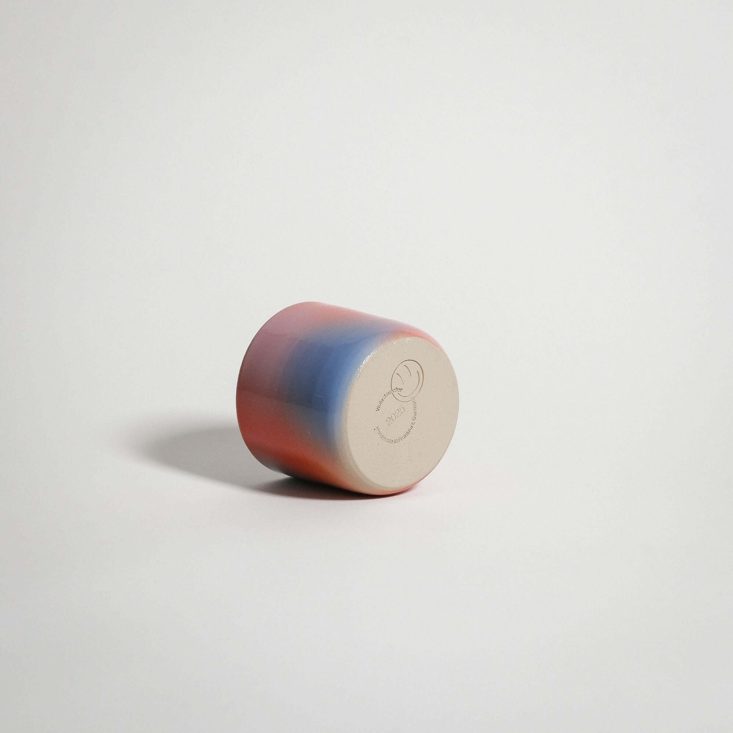 Dawn Coffee Cup handcrafted stoneware in red, blue, and lilac gradient finish.