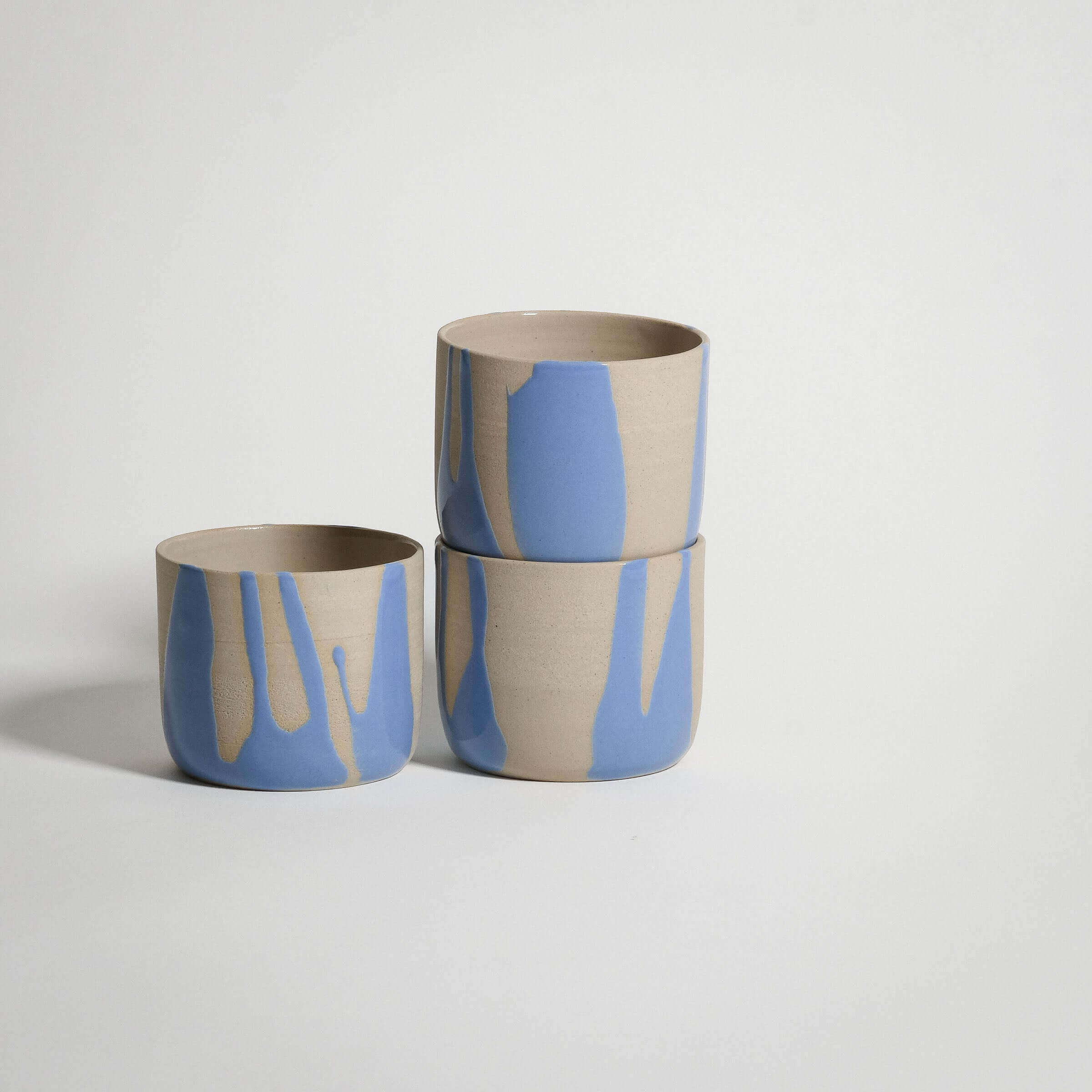 Handcrafted blue stoneware coffee cup set with a glossy finish and unique glaze patterns.