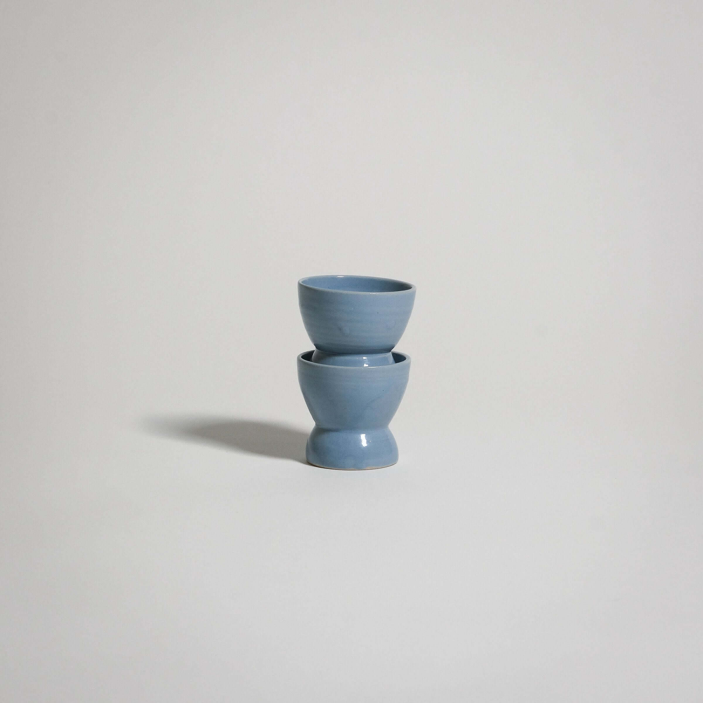 A classic ceramic Egg Cup in the color ice blue. Two of them stacked