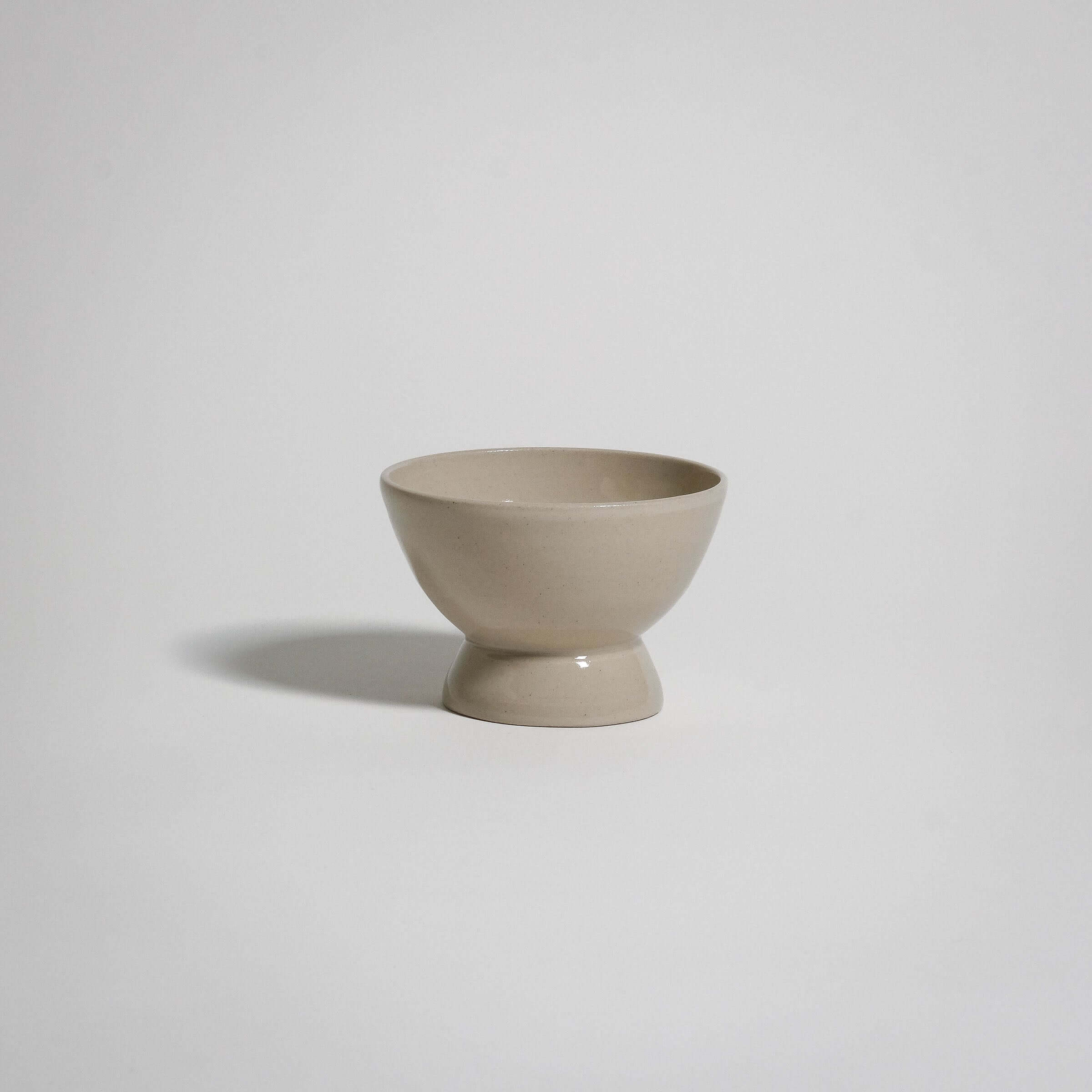 A dessert bowl. It looks like a small bowl on top of a smaller upside down bowl.