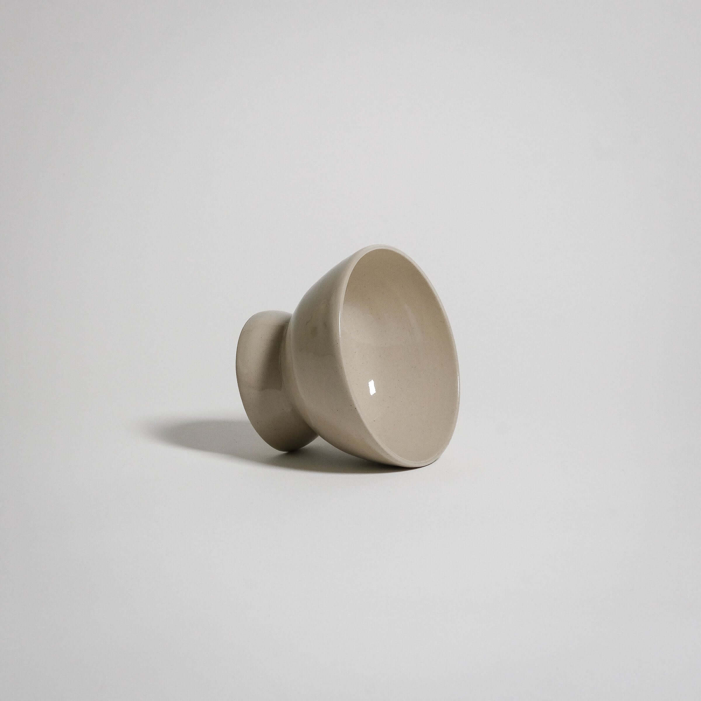 A dessert bowl. It looks like a small bowl on top of a smaller upside down bowl.
