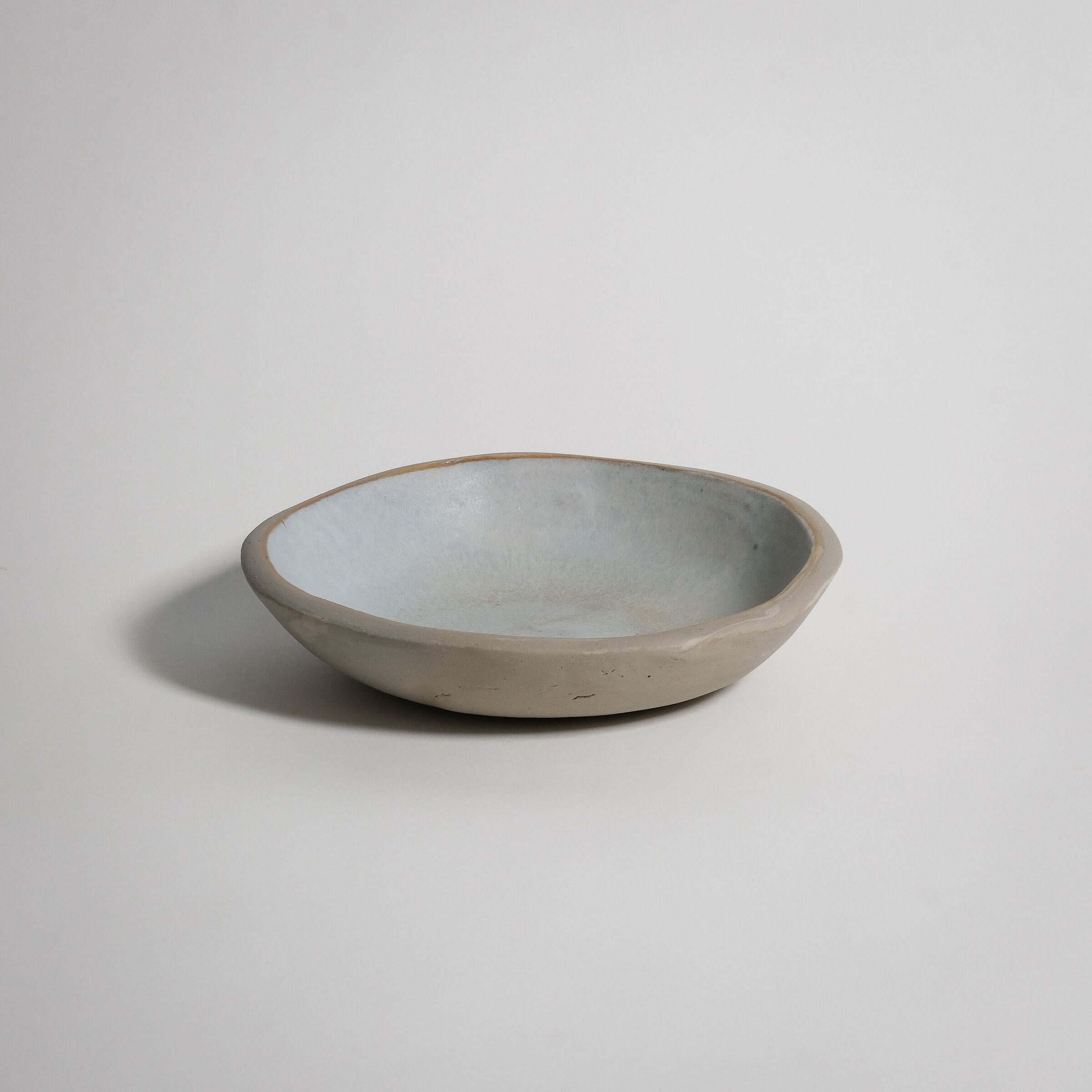 Handbuilt dinner bowl in matte white glaze, food-safe, crafted from grey stoneware clay.