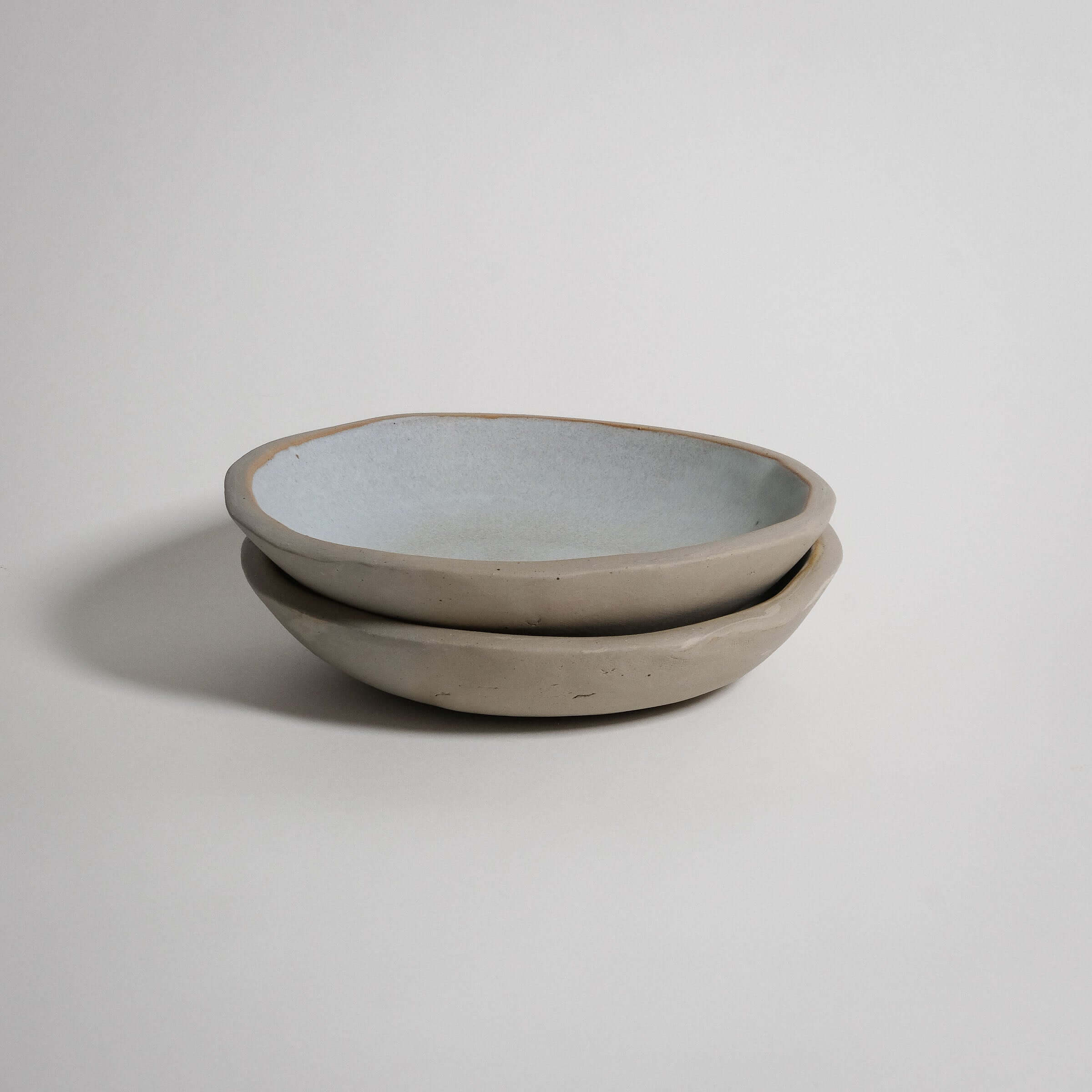 Handbuilt dinner bowl set in matte white and grey stoneware, featuring a food-safe glazed interior.