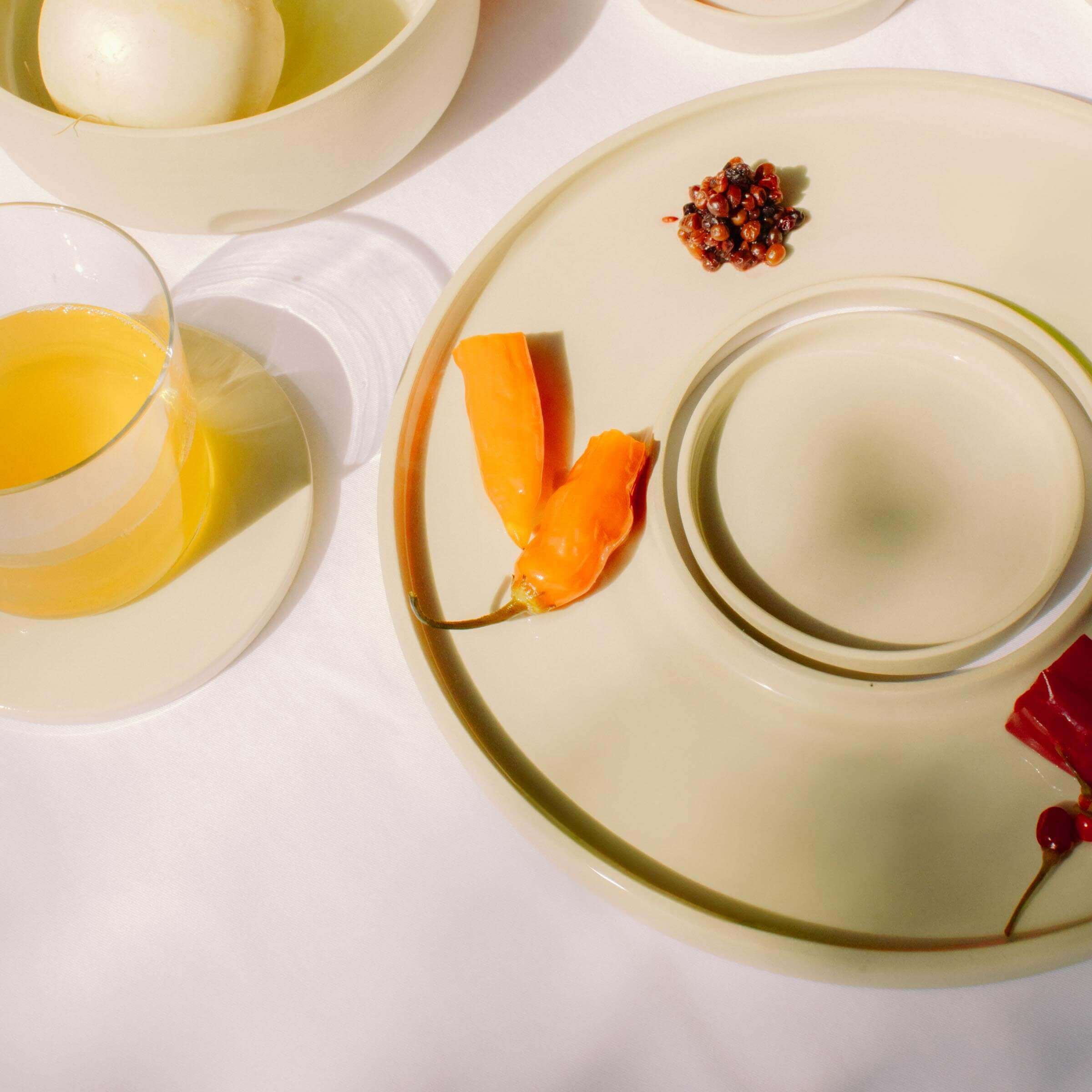 Stylish Tapas Tray Set featuring grey stoneware, mini dish, and colorful garnishes with a beverage.
