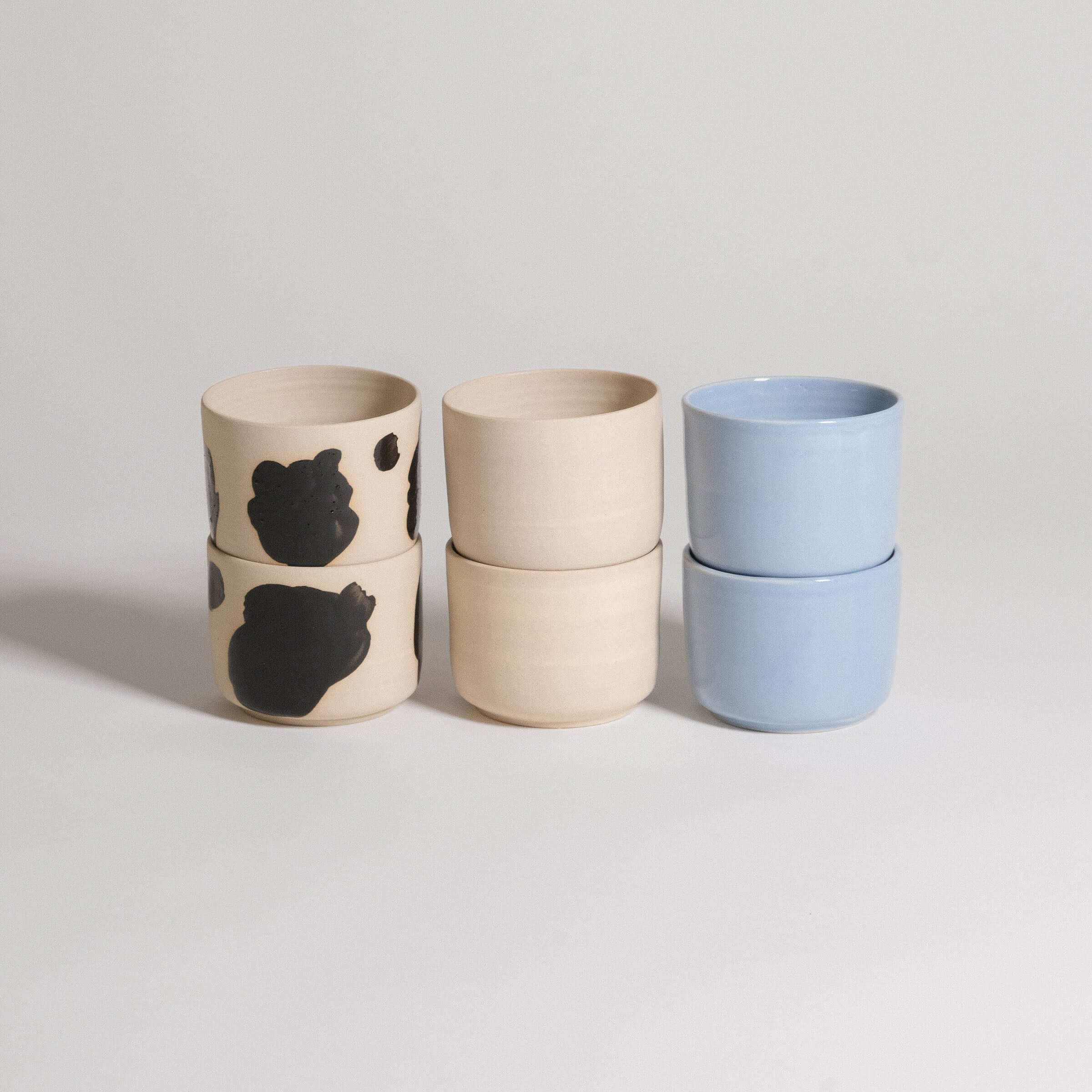 Set of 6 Nomi Coffee Cups in grey stoneware, featuring glossy black hand-painted strokes and ice blue glaze.