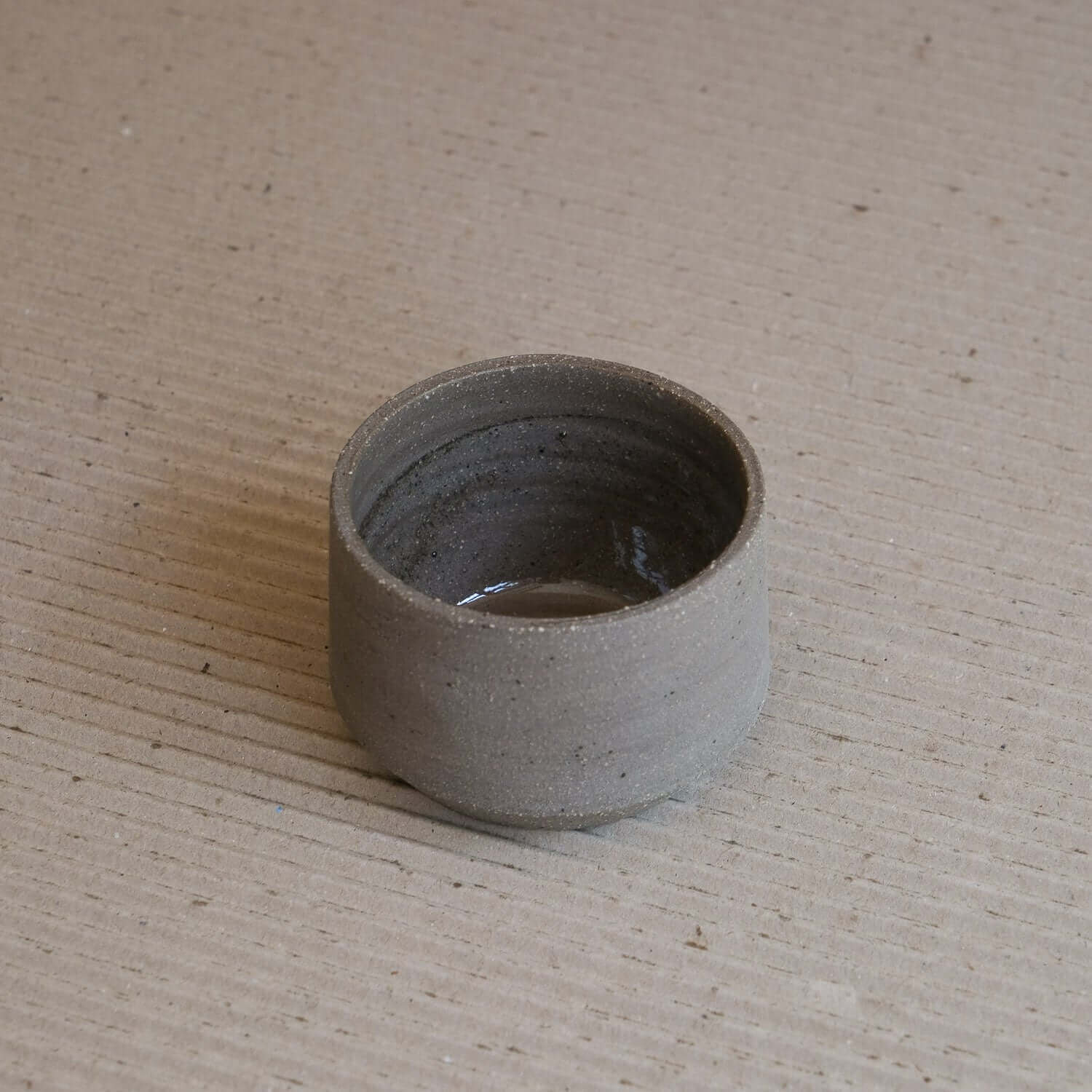 Stoneware Terroir Cup with brown clay, glossy interior glaze, and raw exterior texture.