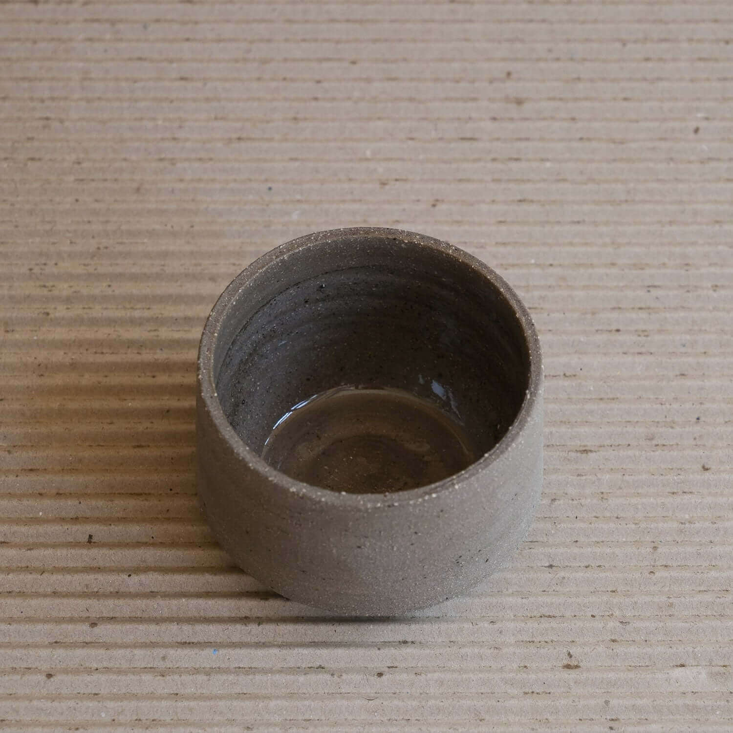 Unique Terroir Cup made from brown clay, featuring a glossy interior glaze and raw exterior texture.