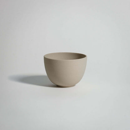 Handcrafted stoneware tea cup Yun Creme with a glossy glaze, showcasing unique ceramic beauty, dishwasher and oven safe.