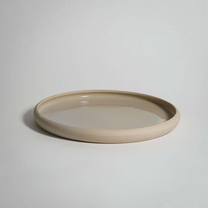 Handcrafted bistro dinner plate in creme, durable stoneware ceramic with transparent glaze, food-safe and unique.