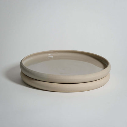 Bistro dinner plate in creme, handcrafted stoneware ceramic with a transparent glaze; dishwasher and oven safe.
