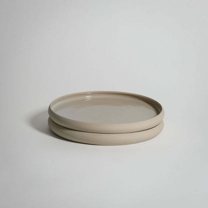 Bistro lunch plate in creme, handcrafted stoneware ceramic with a transparent glaze, showcasing unique character.