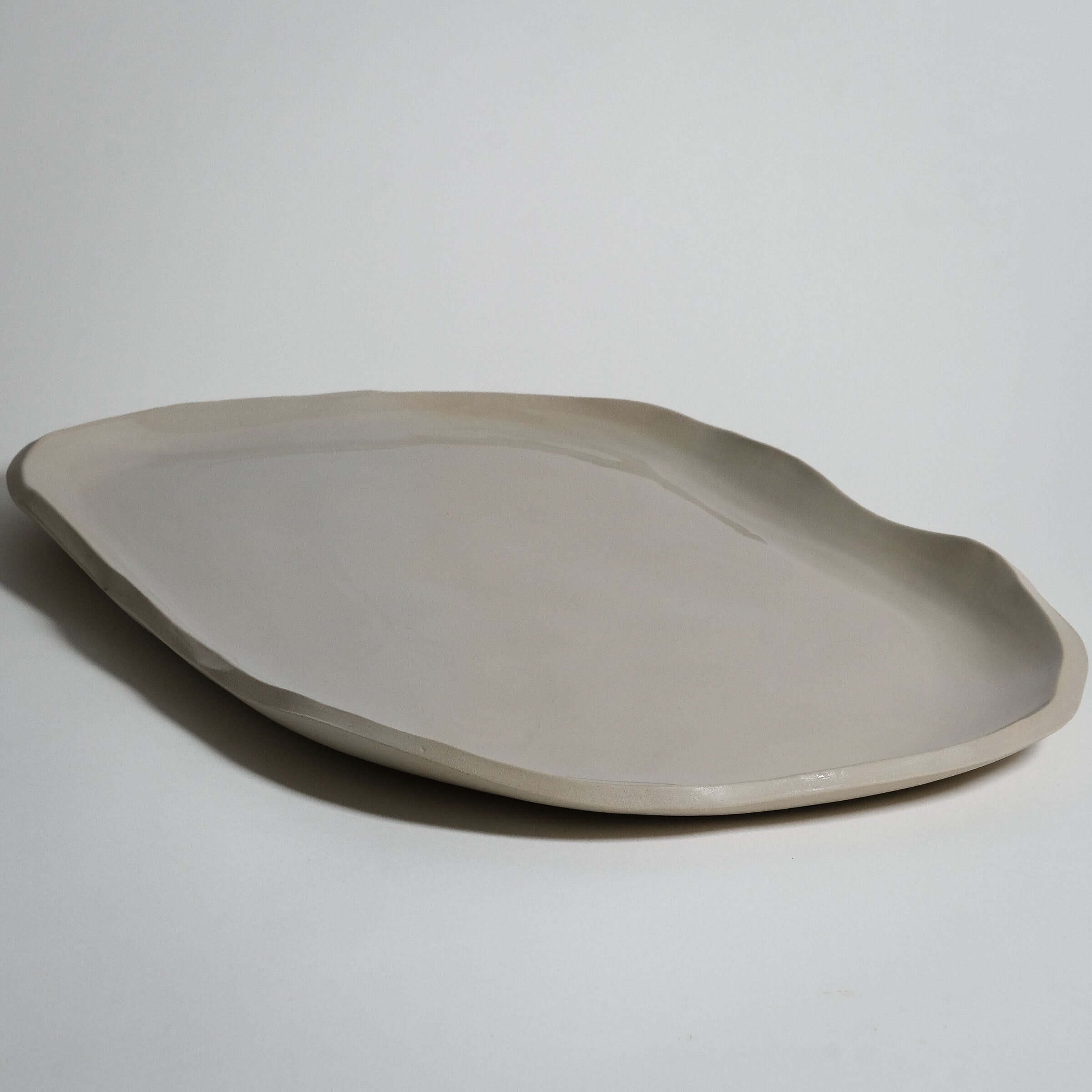 Wide serving tray in creme stoneware ceramic, handcrafted, elegant design, dishwasher and oven safe.
