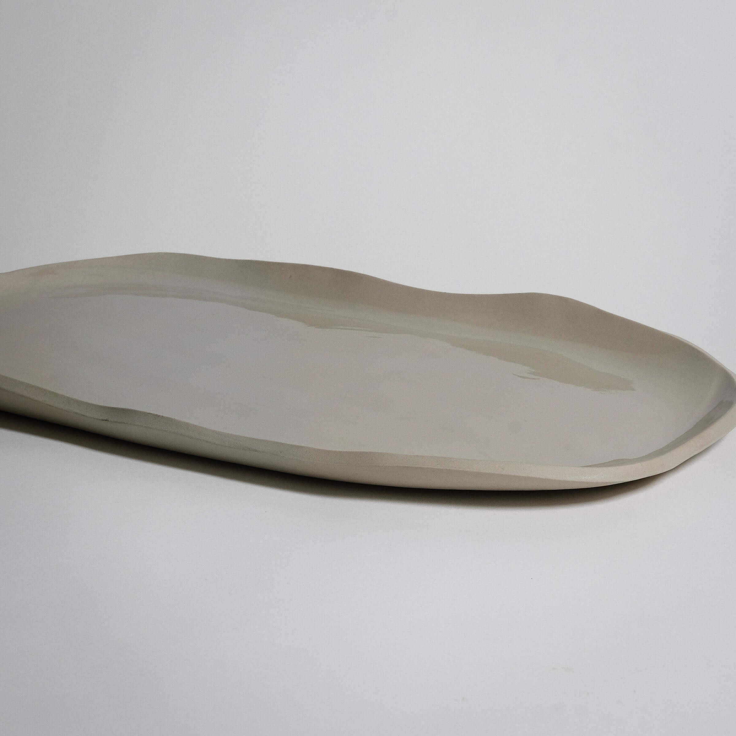 Handcrafted wide serving tray in crème, made from durable stoneware ceramic with an elegant transparent glaze.