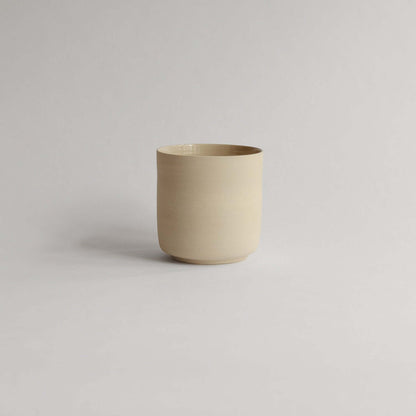 Unique Nomi Creme Tea Cup, 270ml, raw exterior, glossy finish. Perfect touch of artisan craftsmanship for your tea moments. from viola beuscher ceramics