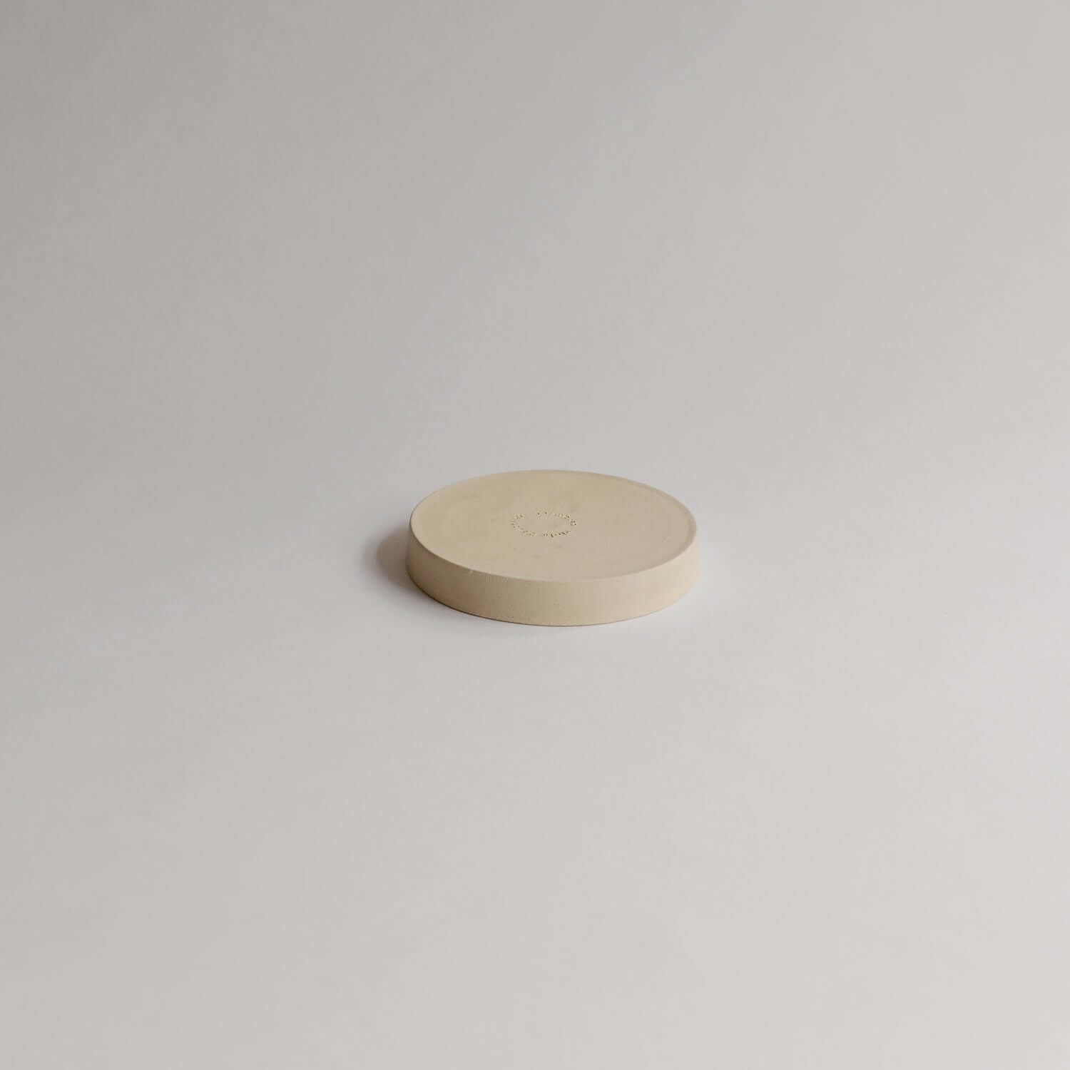 Unique 10cm Mini Dish Creme made of grey stoneware with glossy glaze. Perfect for food, lovingly handcrafted for a distinct touch to your table. von viola beuscher ceramics