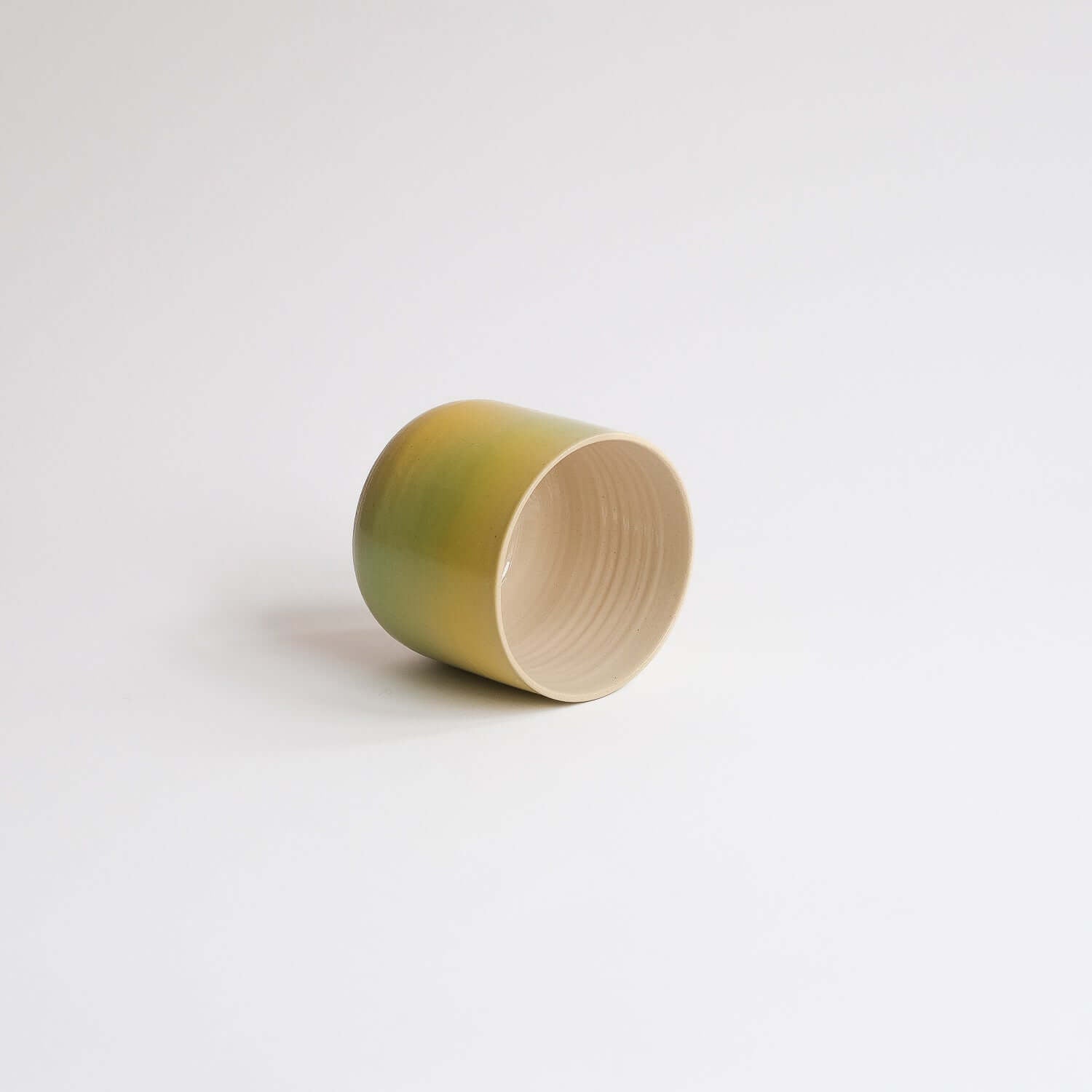 Eye-catching Bloom Cup with vibrant spray-painted design. Perfect size for your coffee delight. Artisanal charm in every sip! from viola beuscher ceramics