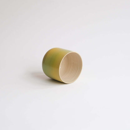 Eye-catching Bloom Cup with vibrant spray-painted design. Perfect size for your coffee delight. Artisanal charm in every sip! from viola beuscher ceramics