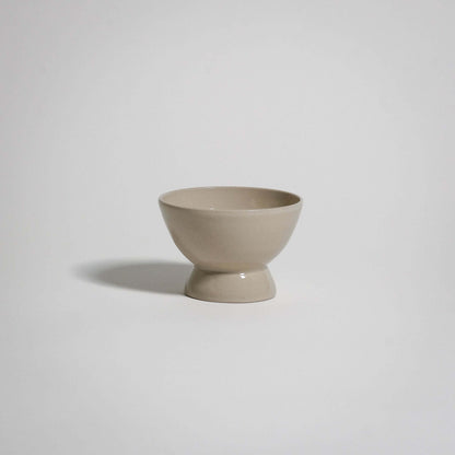A dessert bowl. It looks like a small bowl on top of a smaller upside down bowl.