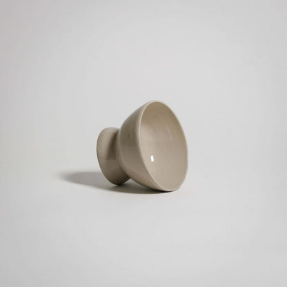A dessert bowl. It looks like a small bowl on top of a smaller upside down bowl.