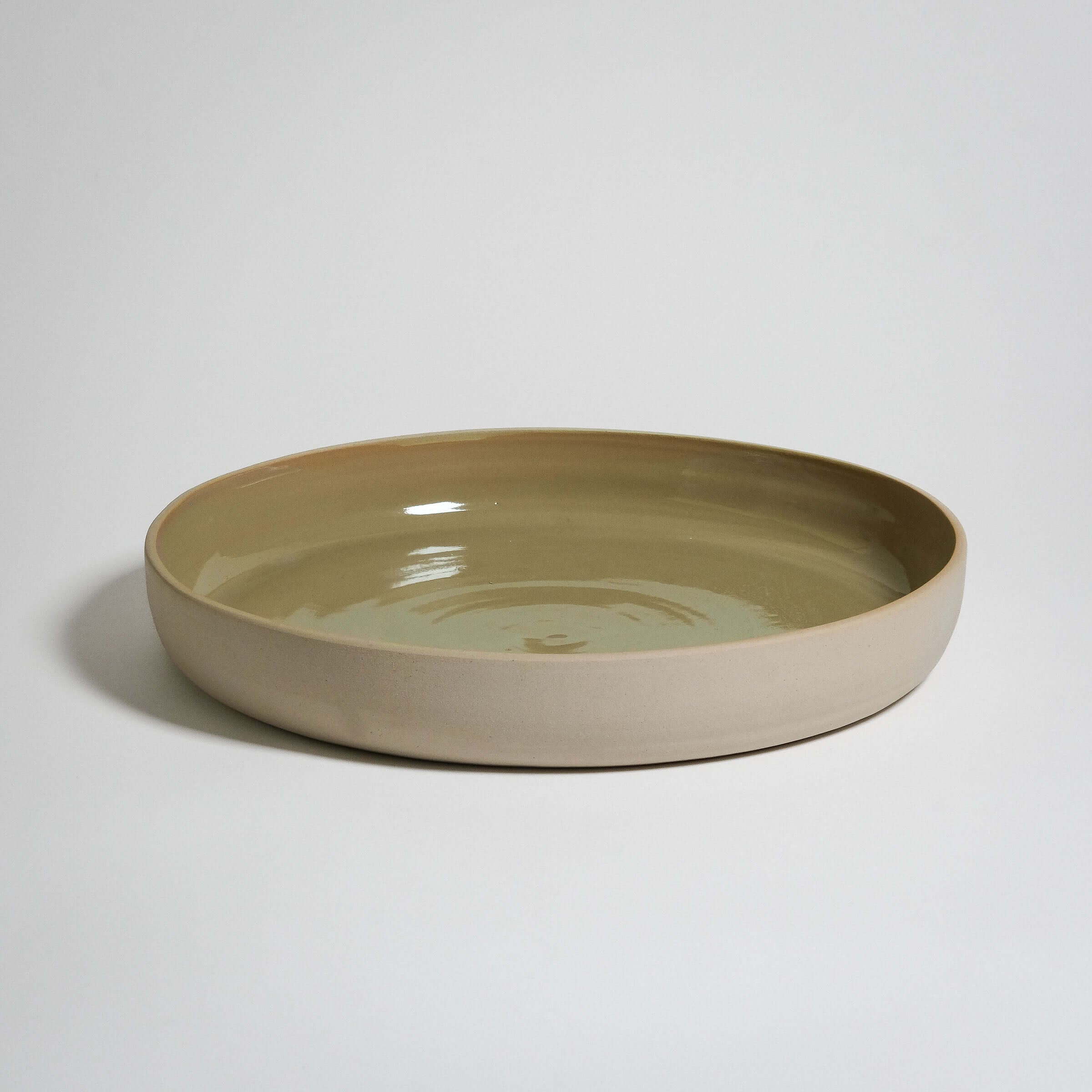 A very big Serving Plate with high rims. Outside is no glazing and inside is a MOSS glazing
