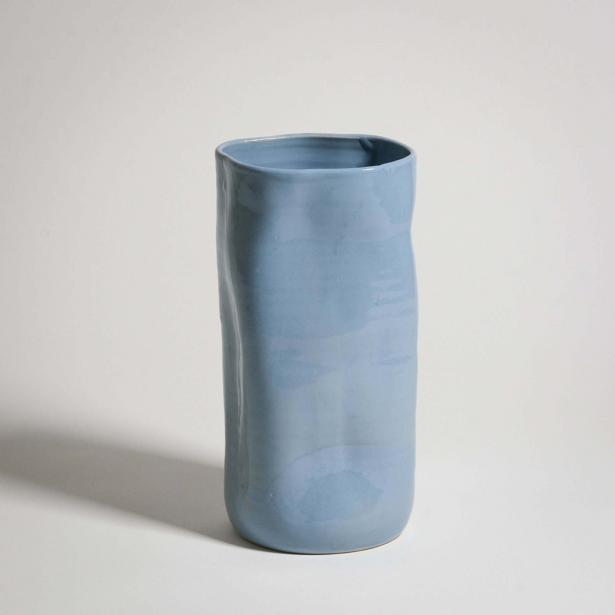 Handcrafted ice-blue stoneware vase with unique color variations and textured glaze.