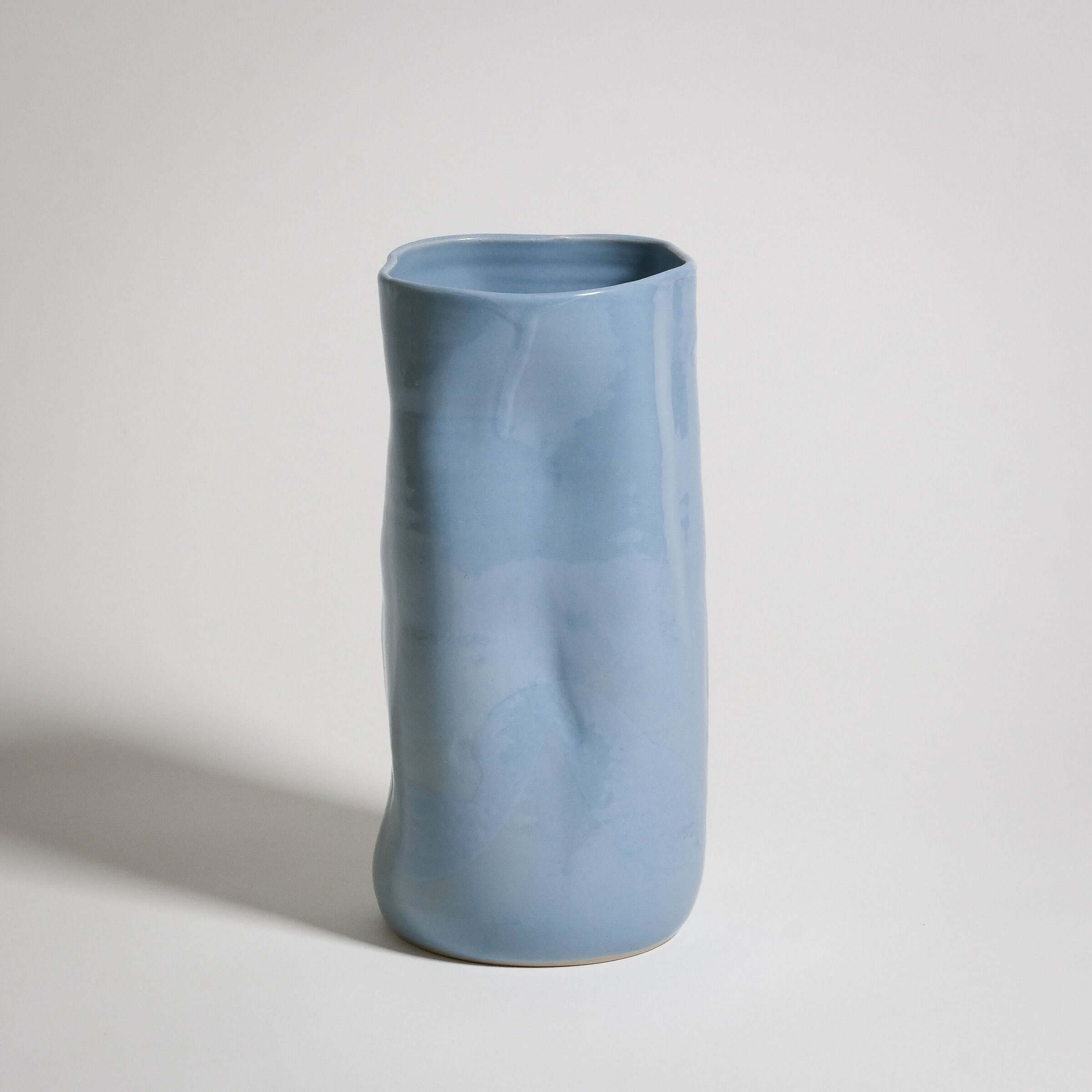 Handcrafted ice-blue stoneware vase with unique texture and color variations.