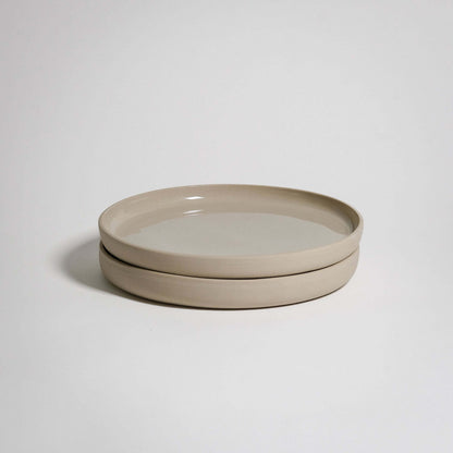 A Medium Plate with a higher rim. The outside is unglazed and the surface is glazed in transparent glaizing