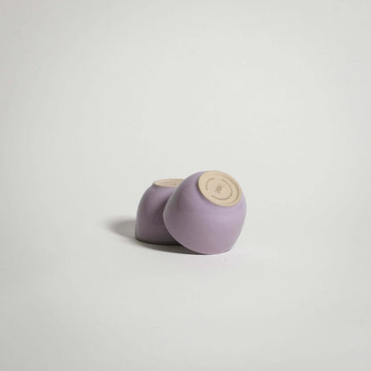 Handcrafted stoneware espresso cups with lilac glaze, showcasing uniqueness and durability for everyday use.