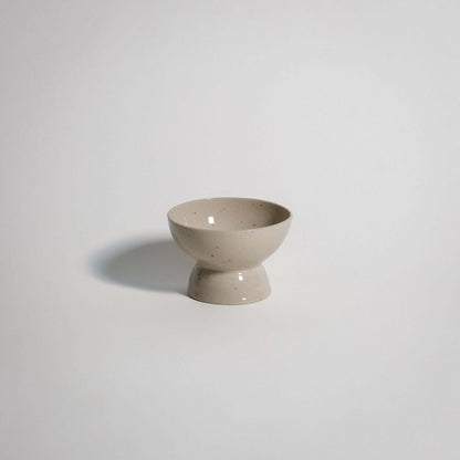 Handcrafted dessert dish in spotted stoneware clay with transparent glaze, food-safe and dishwasher safe.