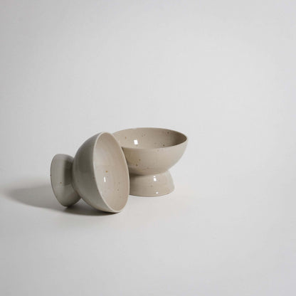 Handcrafted spotted dessert dishes made from durable stoneware, showcasing a natural ceramic glaze.