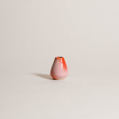 Handcrafted matcha whisk holder in soft pink and red gradient, made from grey stoneware clay.