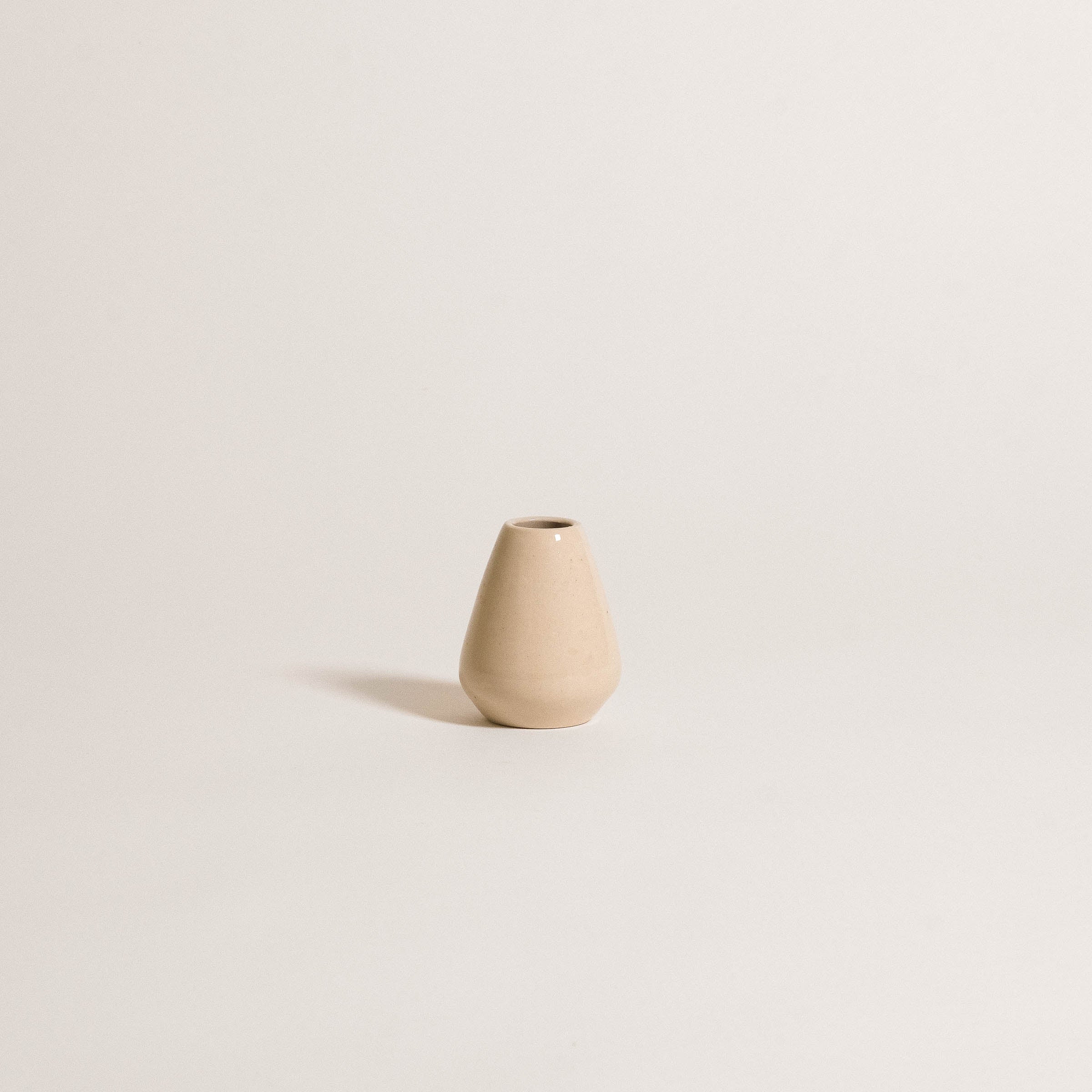 Handcrafted beige stoneware whisk holder, perfect for matcha, showcasing unique texture and glossy finish.