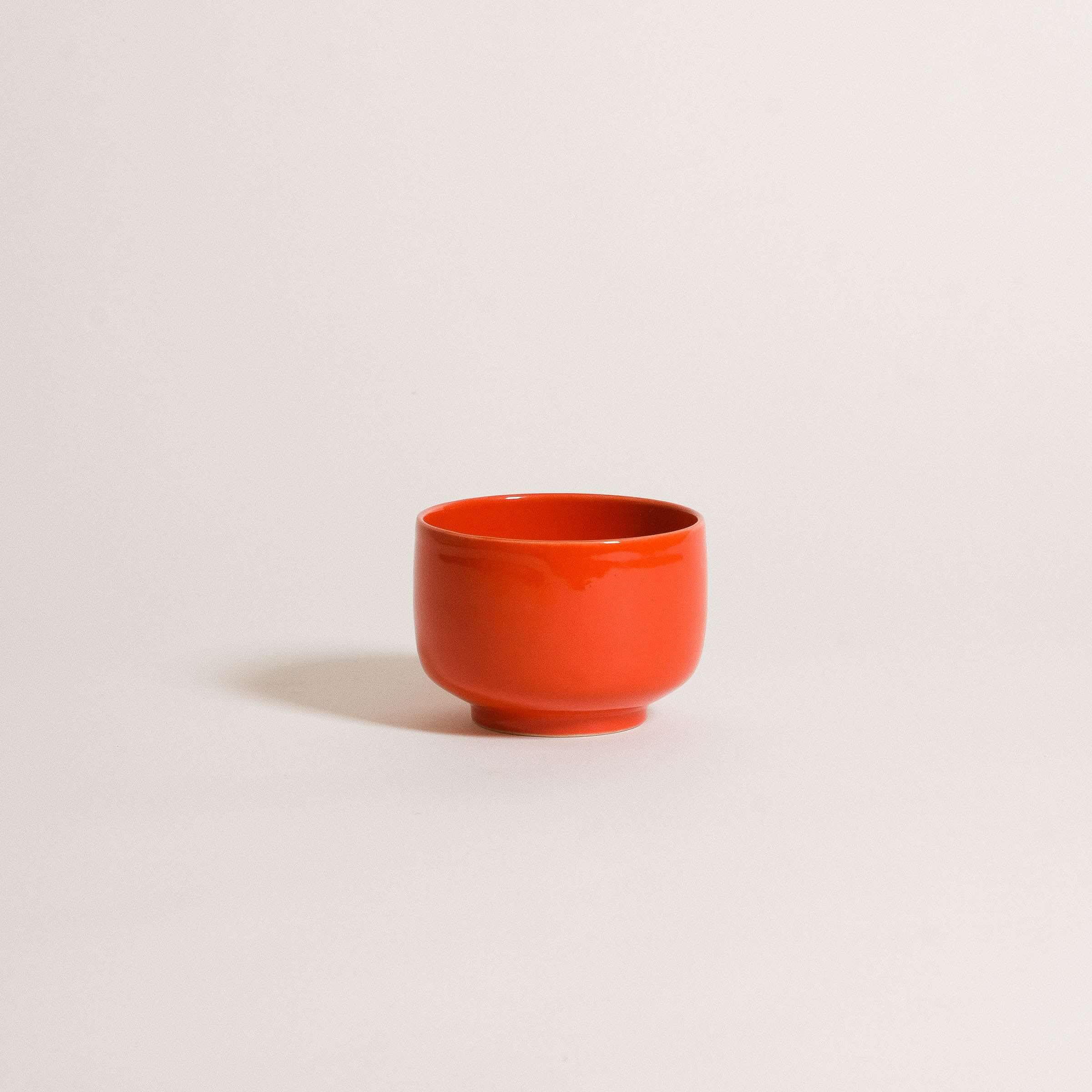 Glossy red matcha cup made from grey stoneware, perfect for iced matcha and latte art.