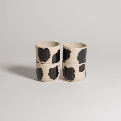 Set of 4 wheel-thrown coffee cups in grey stoneware with glossy black brush strokes, modern and elegant design.
