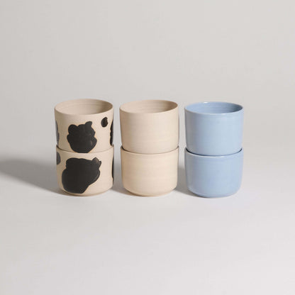 Set of 6 Nomi Coffee Cups in grey stoneware, featuring glossy black hand-painted strokes and ice blue glaze.