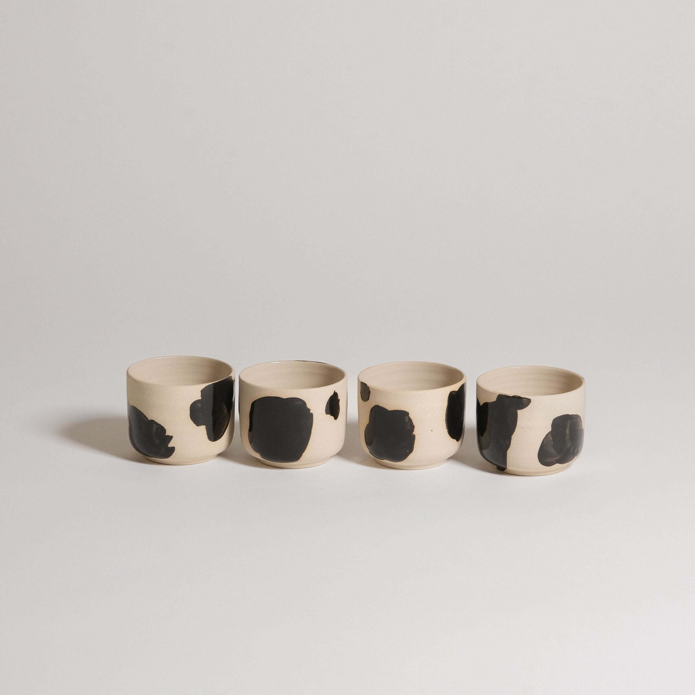 Set of 4 Nomi Pepe espresso cups in grey stoneware with hand-painted black brush strokes.