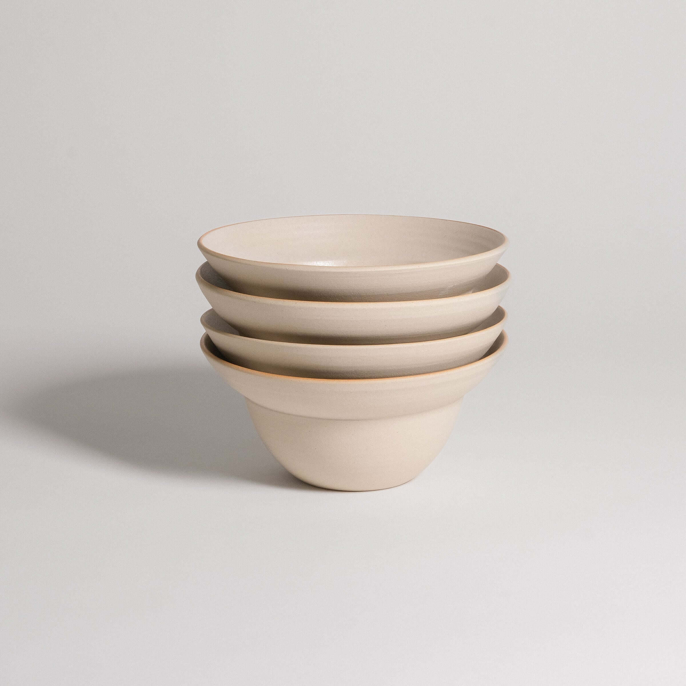 Set of 4 Neo Bowls in White Matte, made of grey stoneware clay with a matte glaze finish.